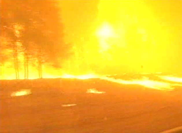 This photo is a still from a WIN TV news video 149.03 -35.34 looking NW at about 16:00 AEDST on 18th January, 2003.